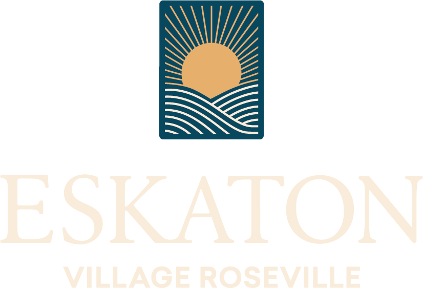 Logo with a stylized sun rising over wavy lines above the partially visible text ESKATON and VILLAGE ROSEVILLE below in light gold on a pale background.