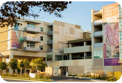 Multi-story Eskaton apartment building with large banners on the exterior advertising Inspired Retirement Living at Moldaw Residences.